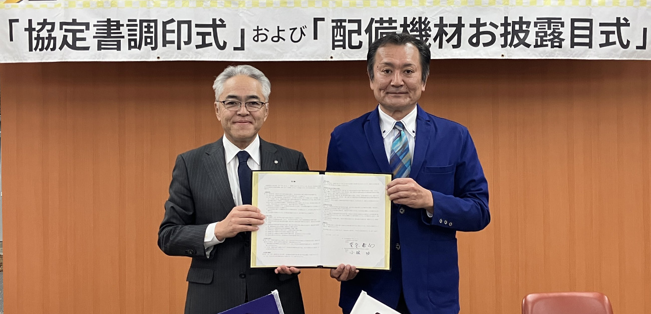 小林町長と菅原理事長の調印の様子