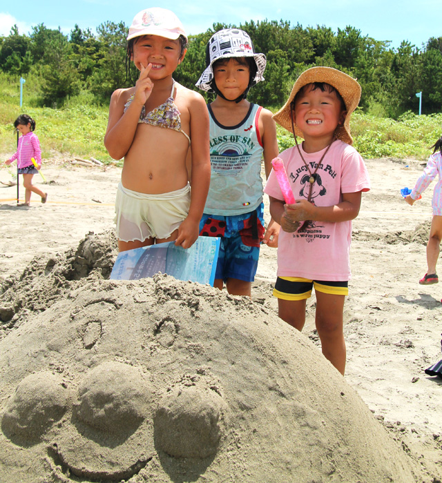 浜辺で砂のアンパンマンを作った女の子たち。上手にできました！そっくり。
