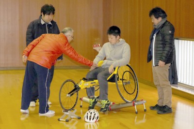 「障がい者スポーツを体験しよう」で競技用車イスに試乗している。講 師は徳島県障がい者スポーツ協会から